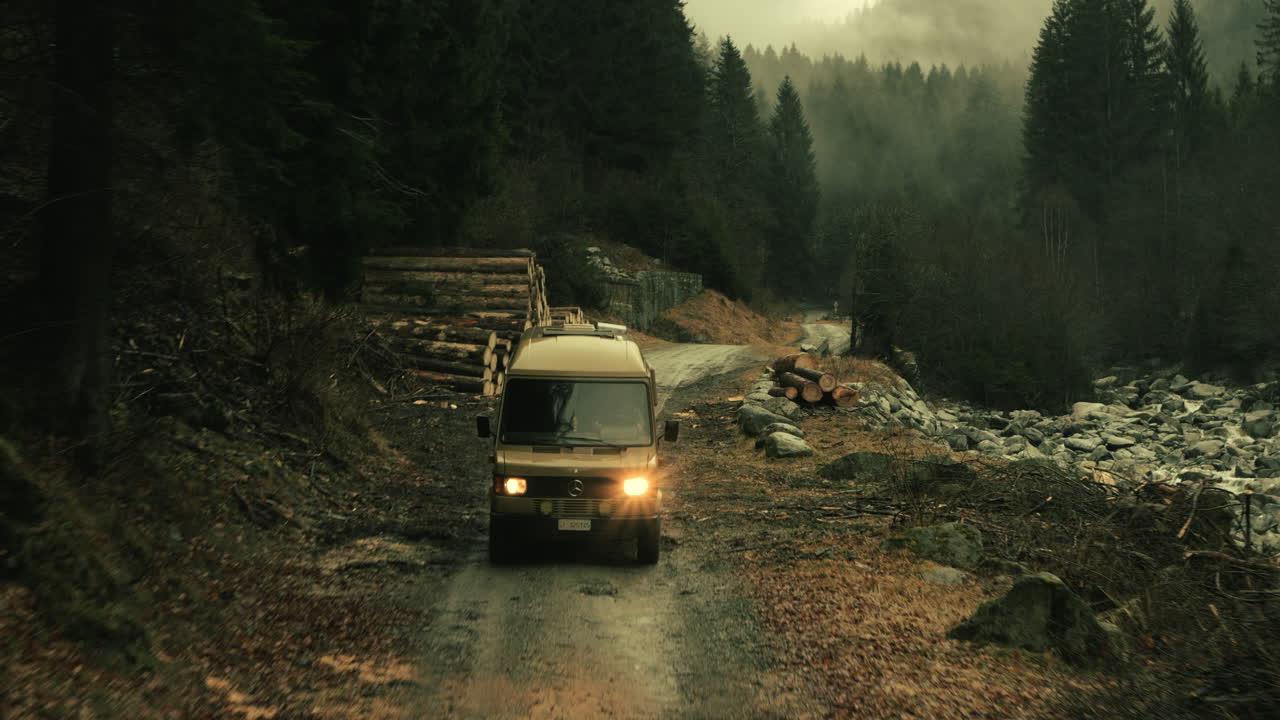 Van Driving Through a Mountain Forest
