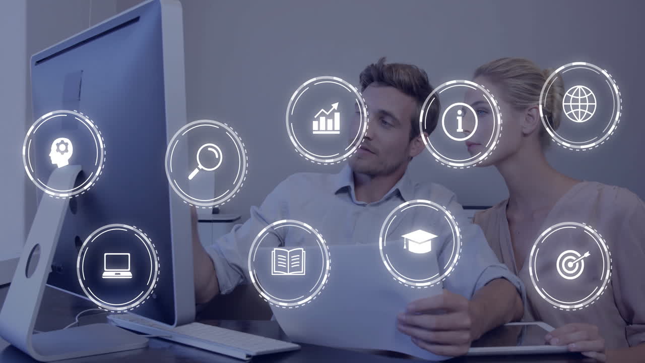 male and female professionals discussing report on desktop in office with floating business icons