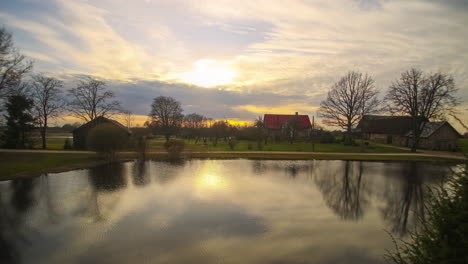 beautiful timelapse view of a farm beginning at sunrise, cloud cover rolls in, the sun appears and concludes at sunset with a magnificent color display and twilight sets in