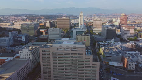 wide aerial over business district towards city hall, los angeles on sunny early morning