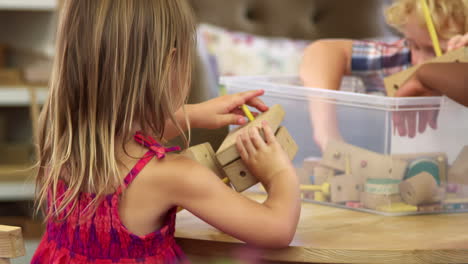 Montessori-School-Pupils-Work-At-Desk-With-Wooden-Building-Set