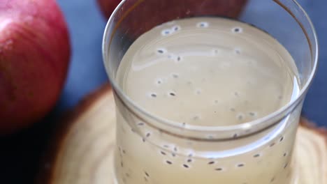 seed apple juice in a glass on table ,