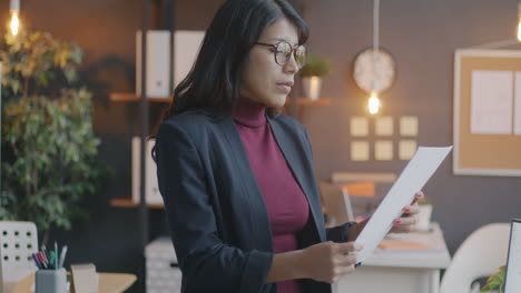 business woman reviewing documents in modern office