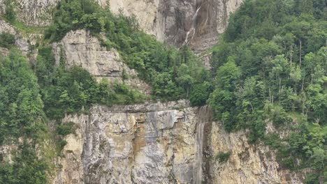 aerial view of seerenbachfälle waterfall in amden, betlis, weesen, overlooking lake walensee in switzerland. majestic cliffs and cascading water create a dramatic alpine scene