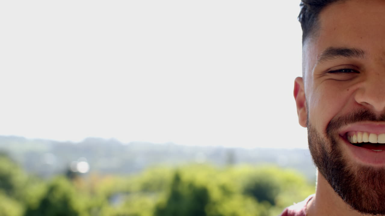 Smiling man enjoying sunny day outdoors, feeling happy and relaxed, copy space