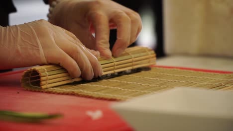 japanese chef preparing sushi rolls