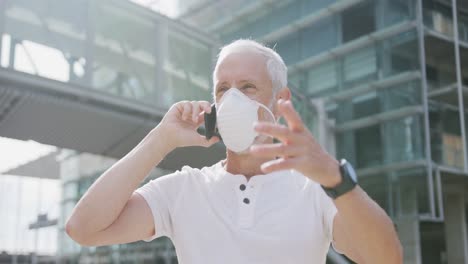 caucasian man out and about in the street wearing on a face mask against coronavirus