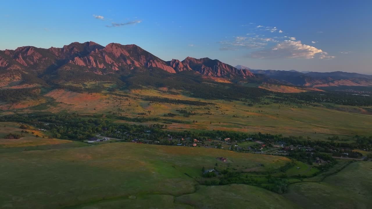 Greenbelt Plateau Flatirons Front Range Boulder Creek neighborhood Chautauqua Park morning sunrise aerial drone Colorado spring summer first light red slanted Rocky Mountains Pikes Peak backwards