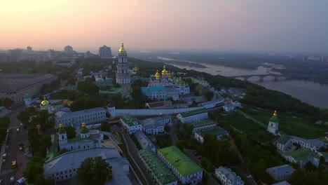 Aerial-view-Kiev-Pechersk-Lavra-on-green-hills-at-evening-sunset-landscape