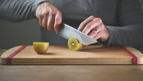 close-up-shot-of-man-slicing-kiwi