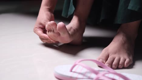 woman massaging sore toes