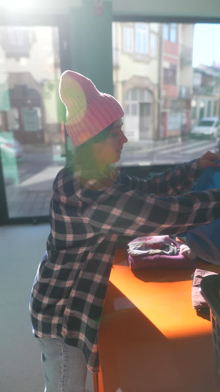 Teenager sorting clothes at a donation center