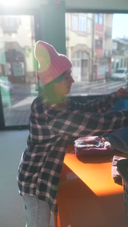 teenager sorting clothes at a donation center