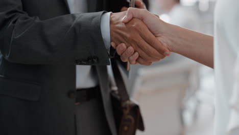 close up business people shaking hands  corporate partnership deal welcoming opportunity for cooperation in office