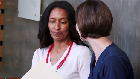 Two-female-doctors-talking-in-a-hospital,-close-up