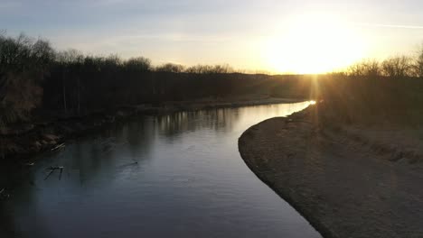 sunrise/sunset over a river with forest