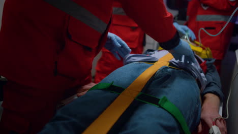 professional paramedics performing first aid procedure in emergency car