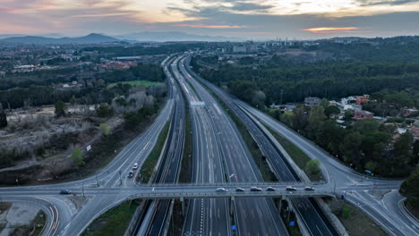 hyper lapse aerial view looking down at speeding traffic vehicles driving rush hour highway at sunset