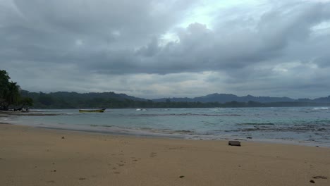 The long, popular Black Beach from a distance, surrounded by tropical vegetation on an overcast morning in Puerto Viejo, Costa Rica.