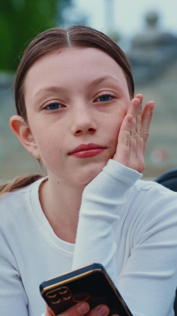 Thoughtful Teenager with Smartphone