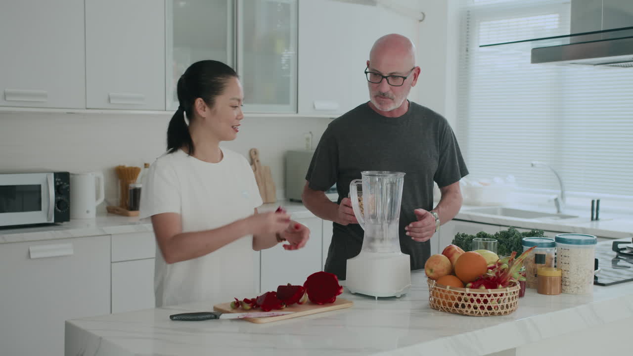 Mature Couple Cutting Fruits for Smoothie at Home