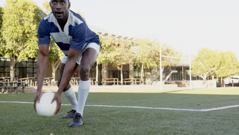 playing rugby, african american male athlete in uniform holding ball on field, preparing, copy space