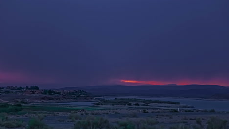 Static-shot-of-red-sunset-sun-setting-behind-the-clouds-in-the-evening-sky-in-time-lapse