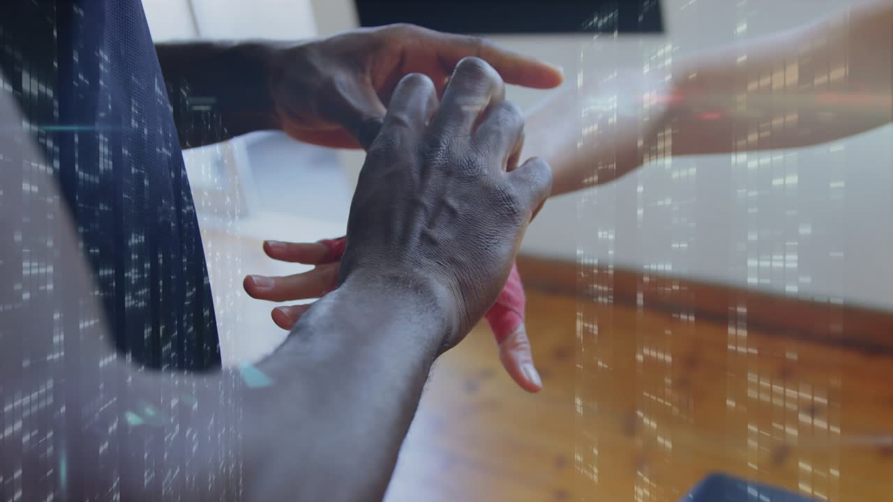 After athlete holding arm coach wrapping hand for sport training applying red wrap overlaying light