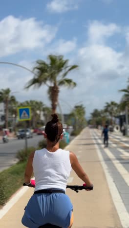 woman cycling on city bike lane