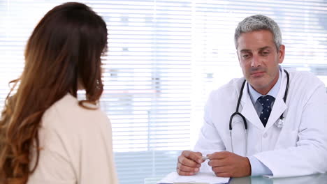 smiling doctor talking to patient