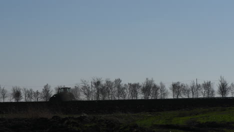 Agricultural-tractor-with-tiller-in-field