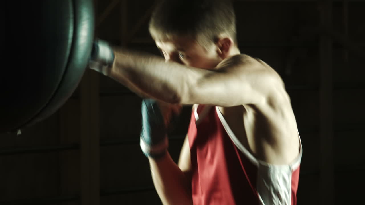 Young Caucasian Boxer Training With a Punching Bag