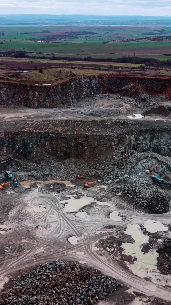 Aerial View of Heavy Machinery Operating in an Open Pit Stone Quarry