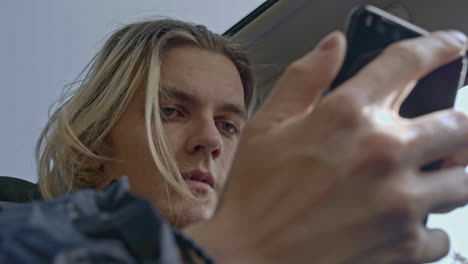 man using smartphone in a car