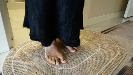 a person standing on a bathroom doormat