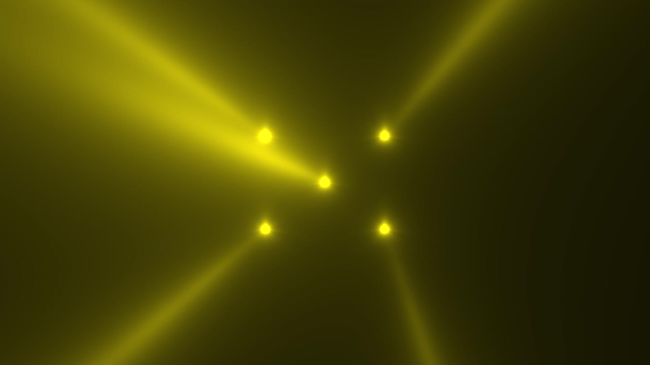 Yellow glowing spotlight beams on black gradient stage