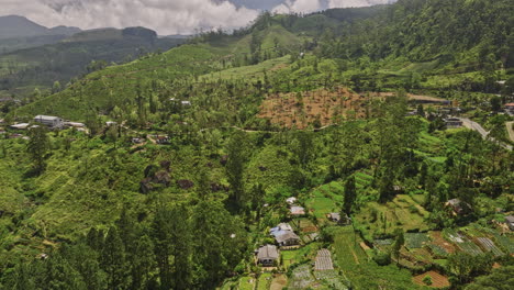 Palagolla-Sri-Lanka-Aerial-v4-drone-flyover-small-village-town-capturing-hilly-mountain-landscape-with-hillside-tea-plantation,-A5-road-and-Kotmale-reservoir---Shot-with-Mavic-3-Cine---April-2023