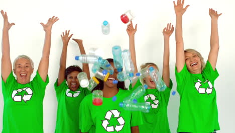 enivromental activist throwing box of recyclables with others cheering