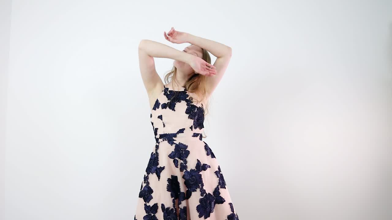 Young Woman in Floral Dress Posing and Dancing