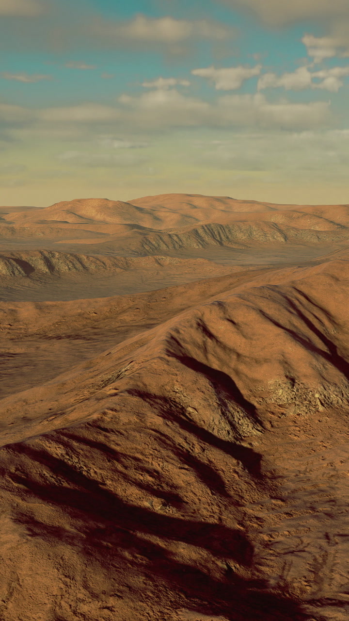 Desert landscape with hills and distant sky during afternoon light