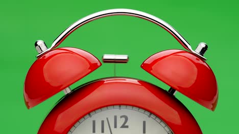 red alarm clock. green screen. close up view.