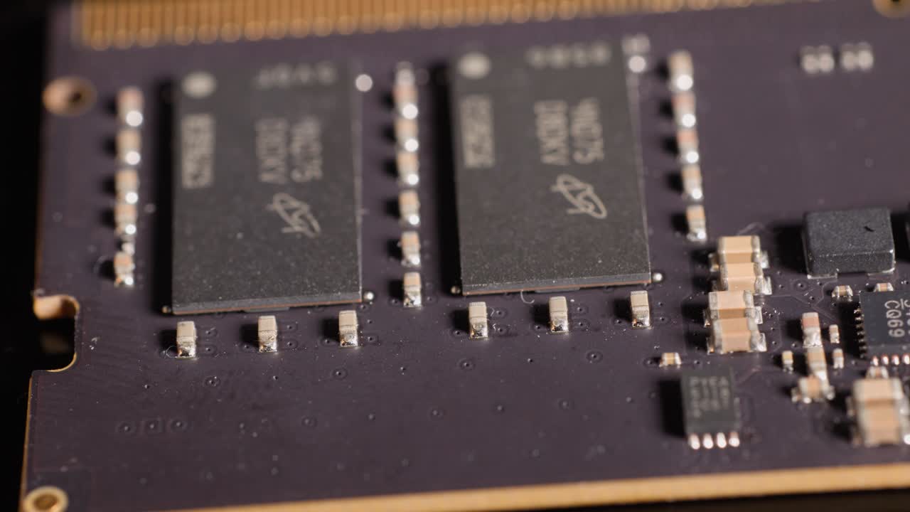 Macro camera movement across a computer memory module reveals detailed electronic components and microchips