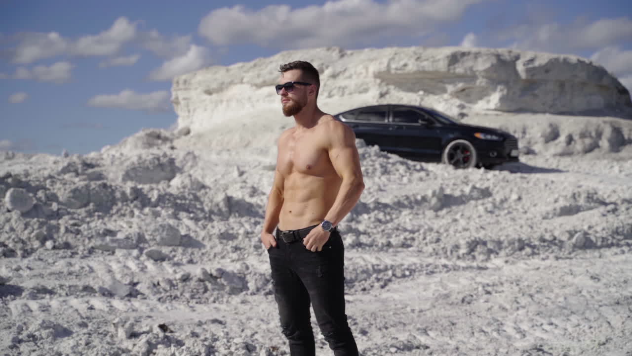 Man with muscular naked torso. Young bearded man in cap with perfect body