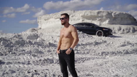 man with muscular naked torso. young bearded man in cap with perfect body