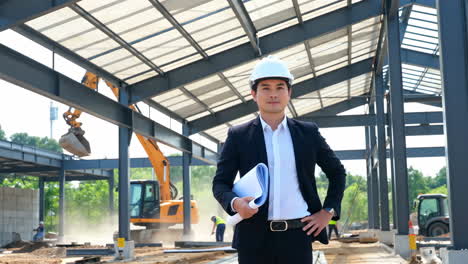 engineer on a construction site with blueprints