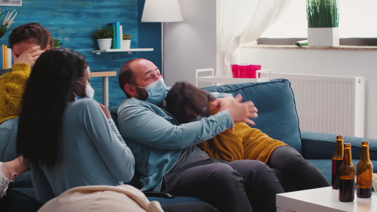 Group of multi ethnic friends watching a horror movie on tv