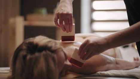 healing asian massage with oil and brushes woman is relaxing in spa-salon neurorelaxation and meditation