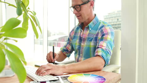 casual designer using graphics tablet and laptop