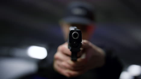 Policewoman-holding-gun-in-hands.-Female-cop-pointing-pistol-at-camera