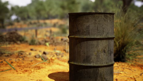 weathered barrel amidst rugged landscape under bright blue sky in afternoon